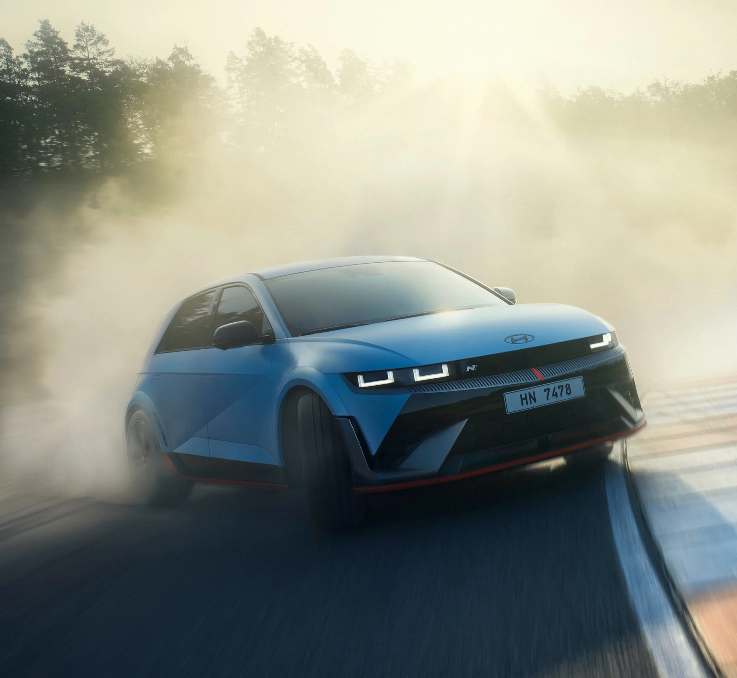 Blue hatchback cornering on a test track