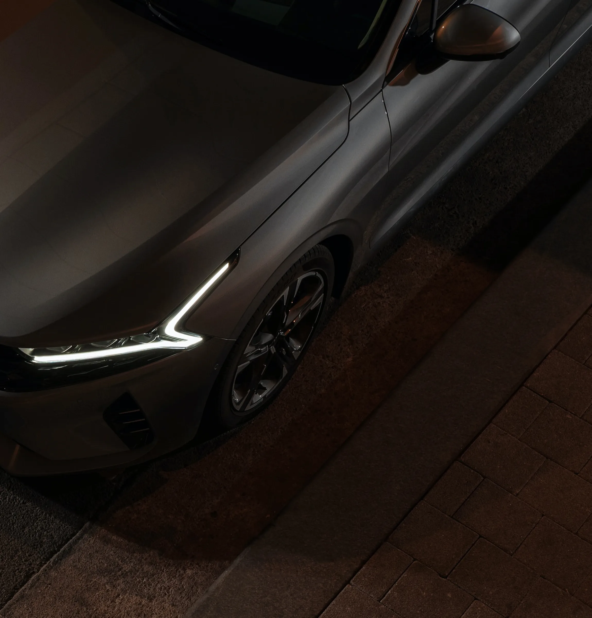 Sedan with headlights on at night